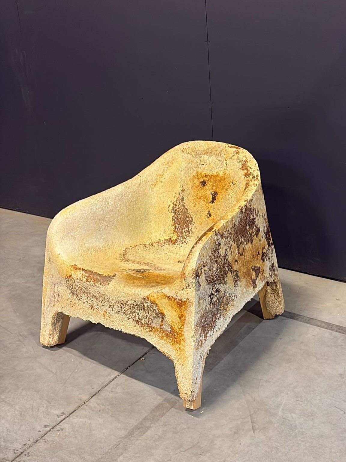 A full-scale grown PALMYCO™ lounge chair prototype against a dark background