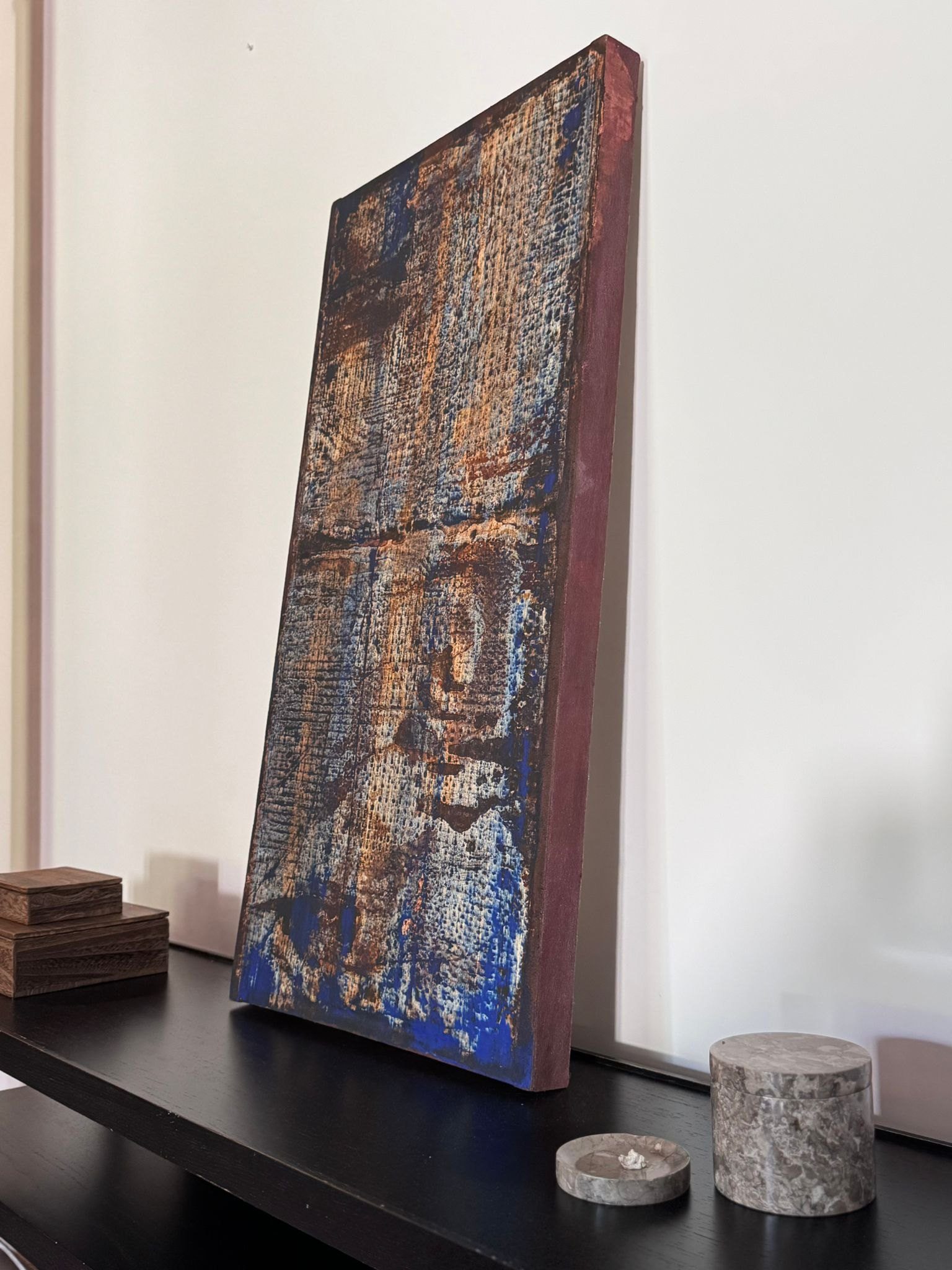 Collaboration Series work leaning on a dark console in an interior