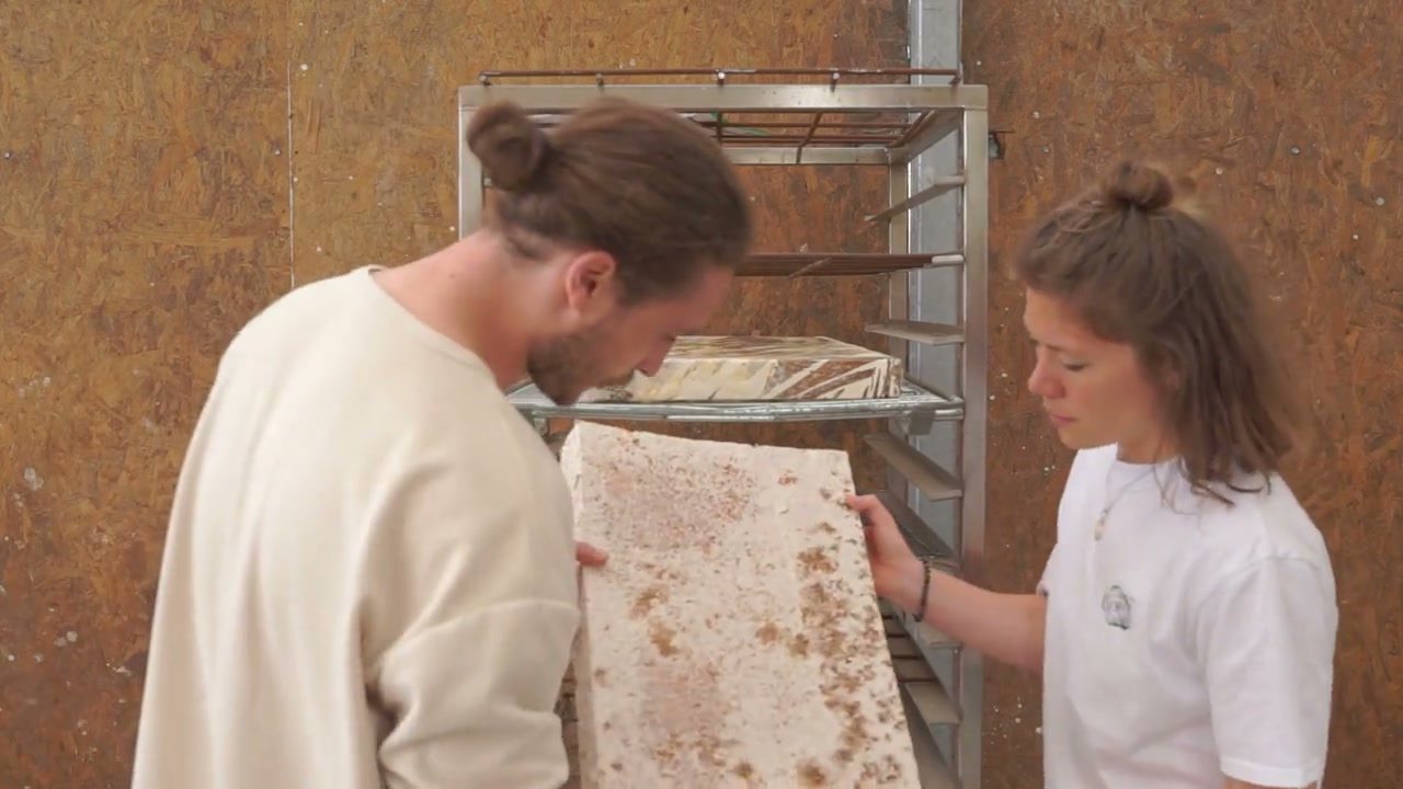 Inspecting a freshly grown panel at the drying rack, from the NUMU process film